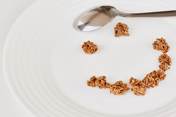 Cereal muesli breakfast and spoon on white background. Healthy eating and lifestyle concept