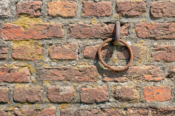Rusty iron ring in old brick wall