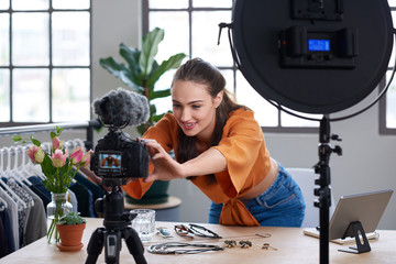Online content creator vlogger adjusting her recording equipment - 216504437