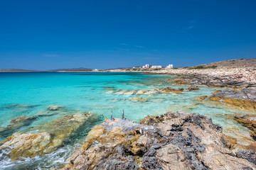 Fototapeta premium Rocky beach with amazing tranquil water on Paros island, Cyclades, Greece.