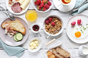 Breakfast food table. Brunch set, meal variety with fried egg, croissants, granola and fresh strawberry. Overhead view - obrazy, fototapety, plakaty