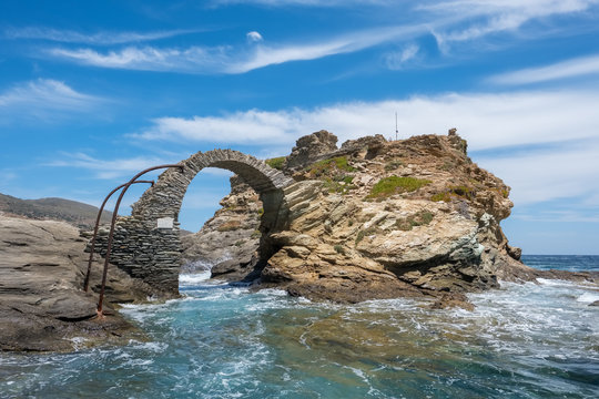 Old arched stone bridge in the beautiful town of Chora on Andros island, Cyclades, Greece © Mazur Travel