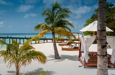 Luxury beach with white sand, coconut palms and pavilions
