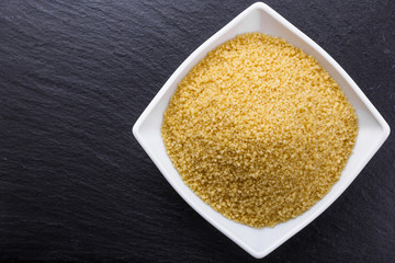 fresh couscous on a dark stone background