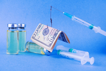 Group of vials with medicineand syringes a trap for the people on blue background.