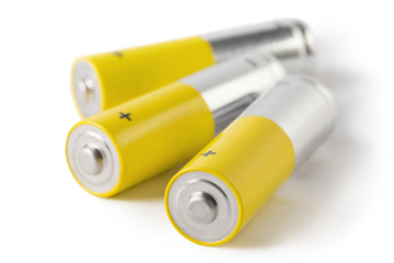 Close-up of three AA batteries, isolated on white background