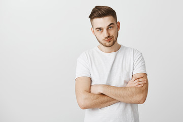 Obraz premium How long it continue. Irritated displeased and impatient stylish mature male standing in queue getting annoyed of customer taking long time to pay smirking frowning and holding hands crossed on chest