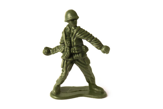Toy soldier throwing a grenade bomb, isolated on white background