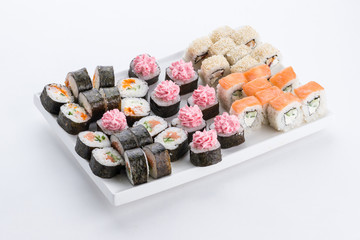 Sushi set and composition at white background. Japanese food restaurant, sushi maki gunkan roll plate or platter set.