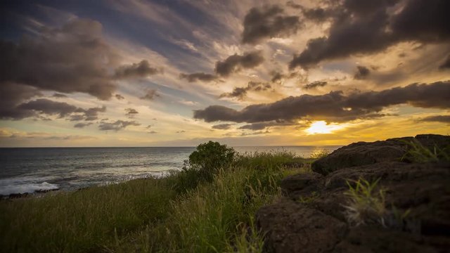Motion time lapse of the sun setting over the ocean off Oahu island, Hawaii