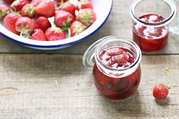 Strawberry marmalade. Homemade strawberry jam in glass jar overhead rustic wooden table. Copy space