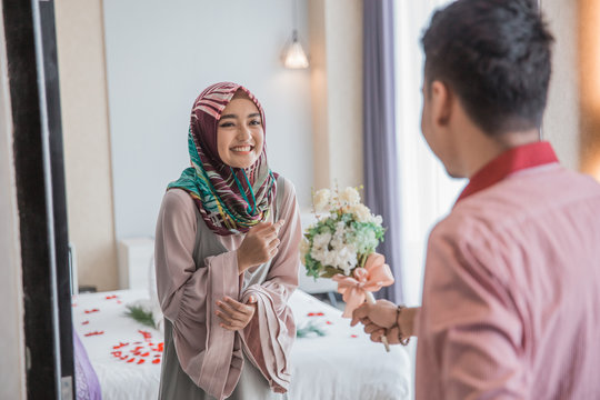 muslim woman receiving flower from her husband