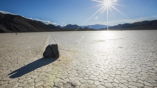 Sunset time lapse over a moving rock on the Racetrack Playa of Death Valley National Park, in California