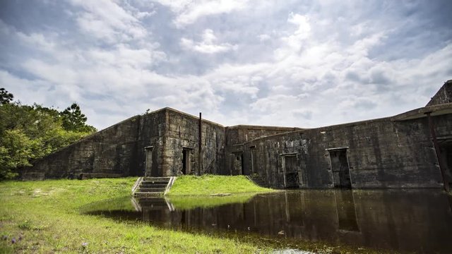 Motion time lapse of the daytime clouds, panning the Battery Bowyer at Fort Morgan historic bastion, at Mobile Bay, Alabama