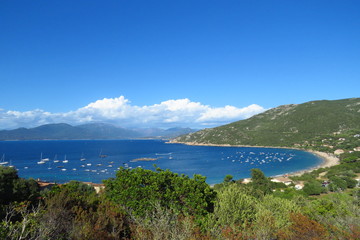 Campomoro beach, a deep blue sea and white sand surrounded by green hills, Corsica, France