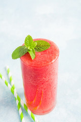 Glass of fresh watermelon beverage with mint