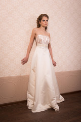 Bride in a wedding dress with hair and makeup in vintage interiors.