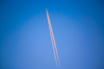 A plane flies high in the sky.