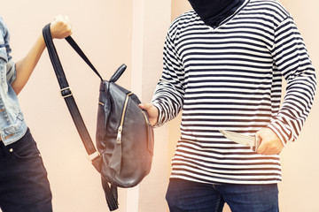 Robber  use knife to scare young woman and try to rob her car.Thief Dangerous man or masked robber...