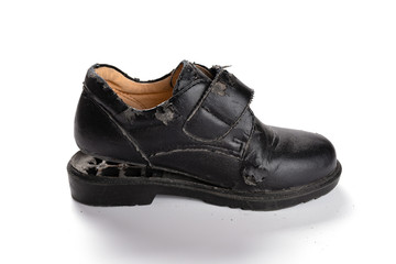 a badly broken leather shoe on white background