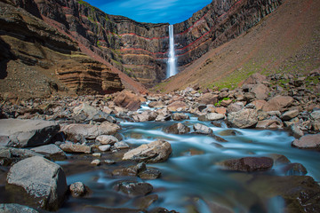 Hengifoss Waterfall in Eastern Iceland with river on the foreground. natural travel landscape