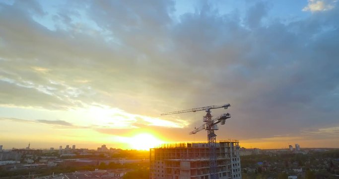 City sunset on the background of forests and construction