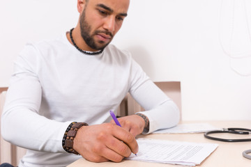 Man sitting completing a questionnaire