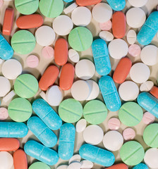 Colorful pills and tablets background frame