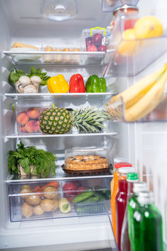 Fresh food abundance in open fridge