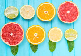 Still life of assorted halved fresh citrus fruit