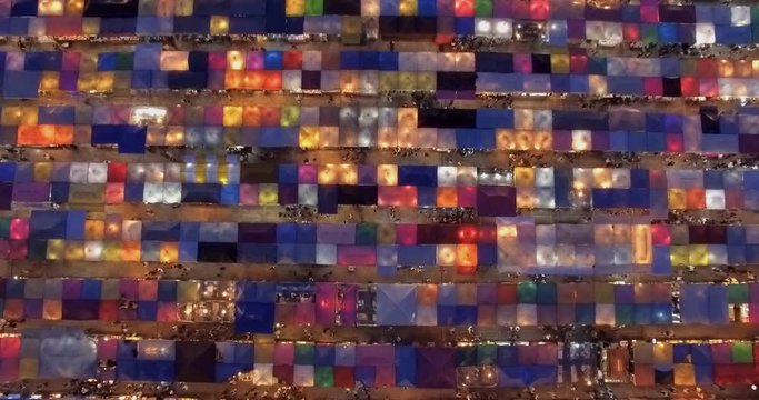 Time-lapse view of the colorful market, traditional Train Night Market Ratchada and the Neon Train Market in Bangkok, Thailand, captured by drone footage.