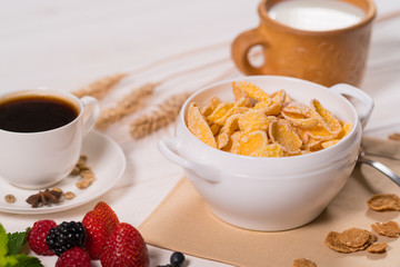 Bowl of breakfast cereal with cup of coffee