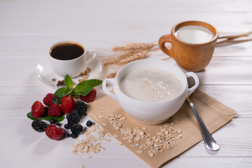 Oatmeal porridge with fruits and cup of coffee