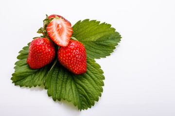 Juicy fresh strawberry on a white acrylic background