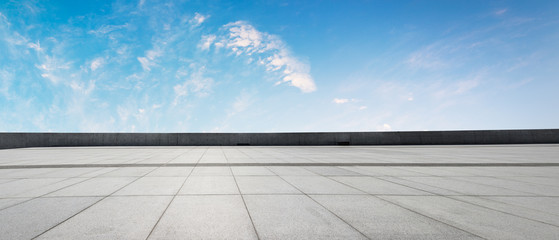 Clean square floor and blue sky with white clouds
