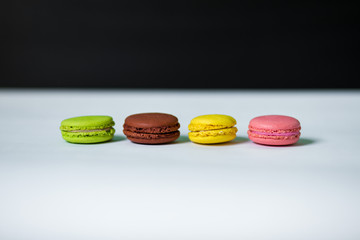 Cake macaron or macaroon on table with black background, sweet and colorful dessert