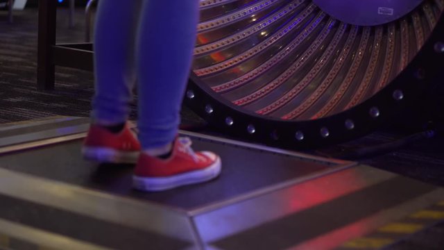 4K shot of a girl playing the jump rope game at an arcade.