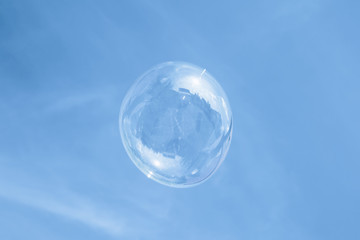 Fototapeta na wymiar soap bubble against the blue sky 