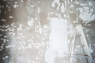 white repairing for painting with dirty ladder the decoration cement wall construction background