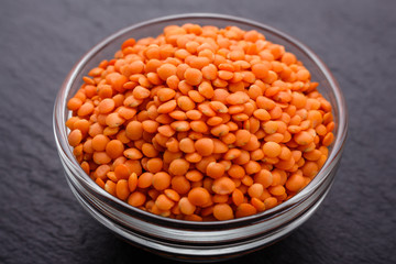 raw lentils on a dark stone background