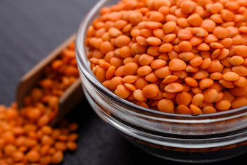 raw lentils on a dark stone background