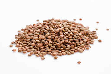 raw lentils on a white acrylic background