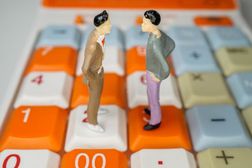 電卓の上で向かい合う男性