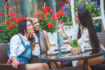 Group of young women making selfie outdoors