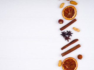 Fototapeta na wymiar Mulled wine ingredients spices. Anise orange, cinnamon on white wooden table. Top view with copy space
