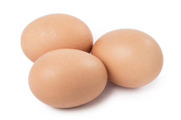 Three brown eggs, isolated on white background