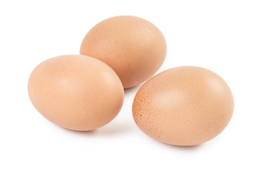 Three brown eggs, isolated on white background