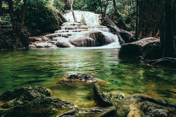 Naklejka na ściany i meble beautiful waterfall in green forest
