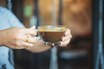 close up of a woman hands holding a coffee cup