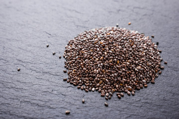 chia seeds on a dark stone background
